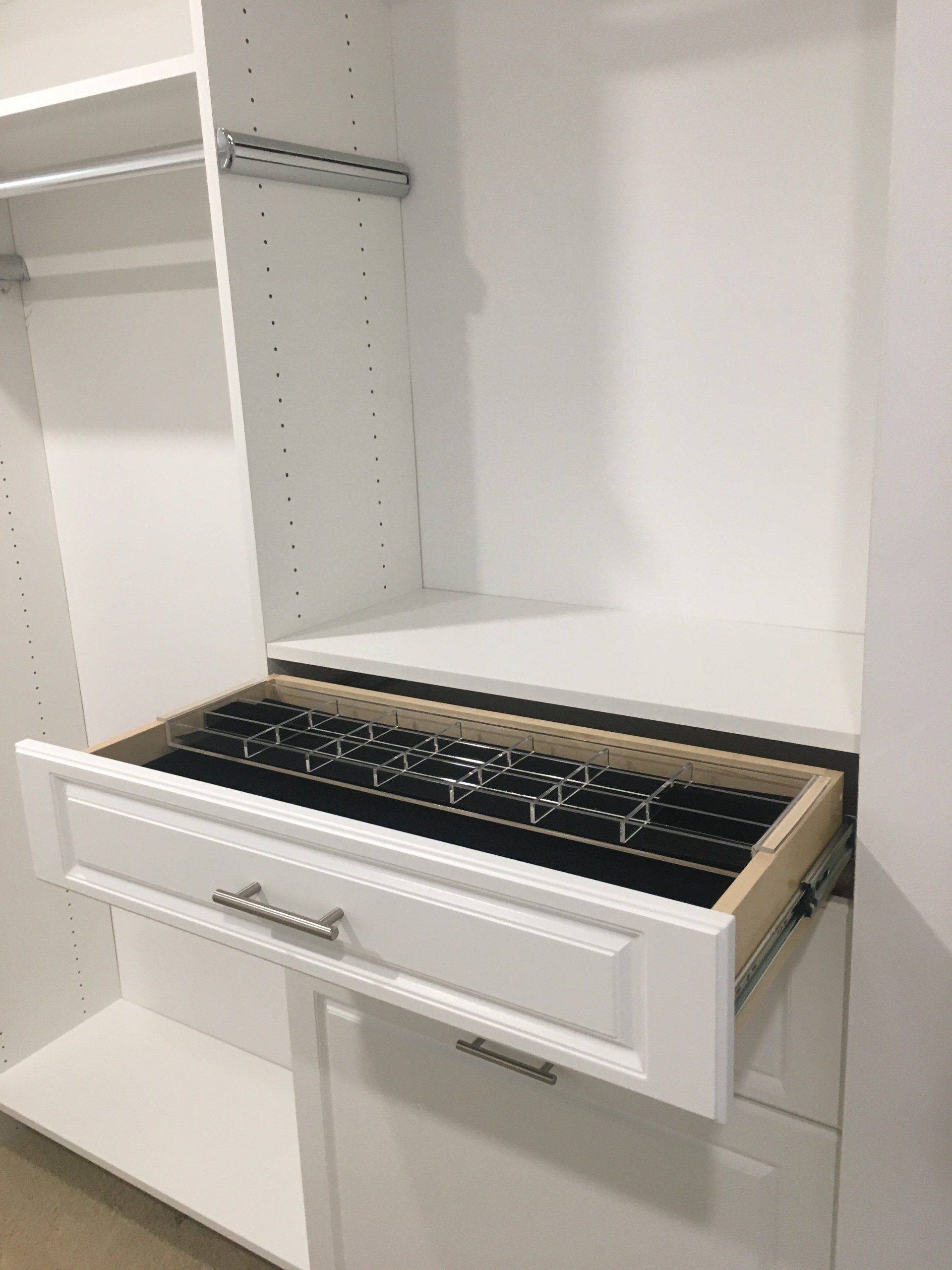 a custom closet cabinet with jewelry tray accessory