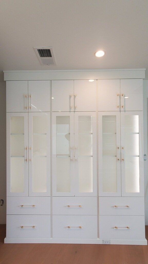 a closet armoire with glass doors