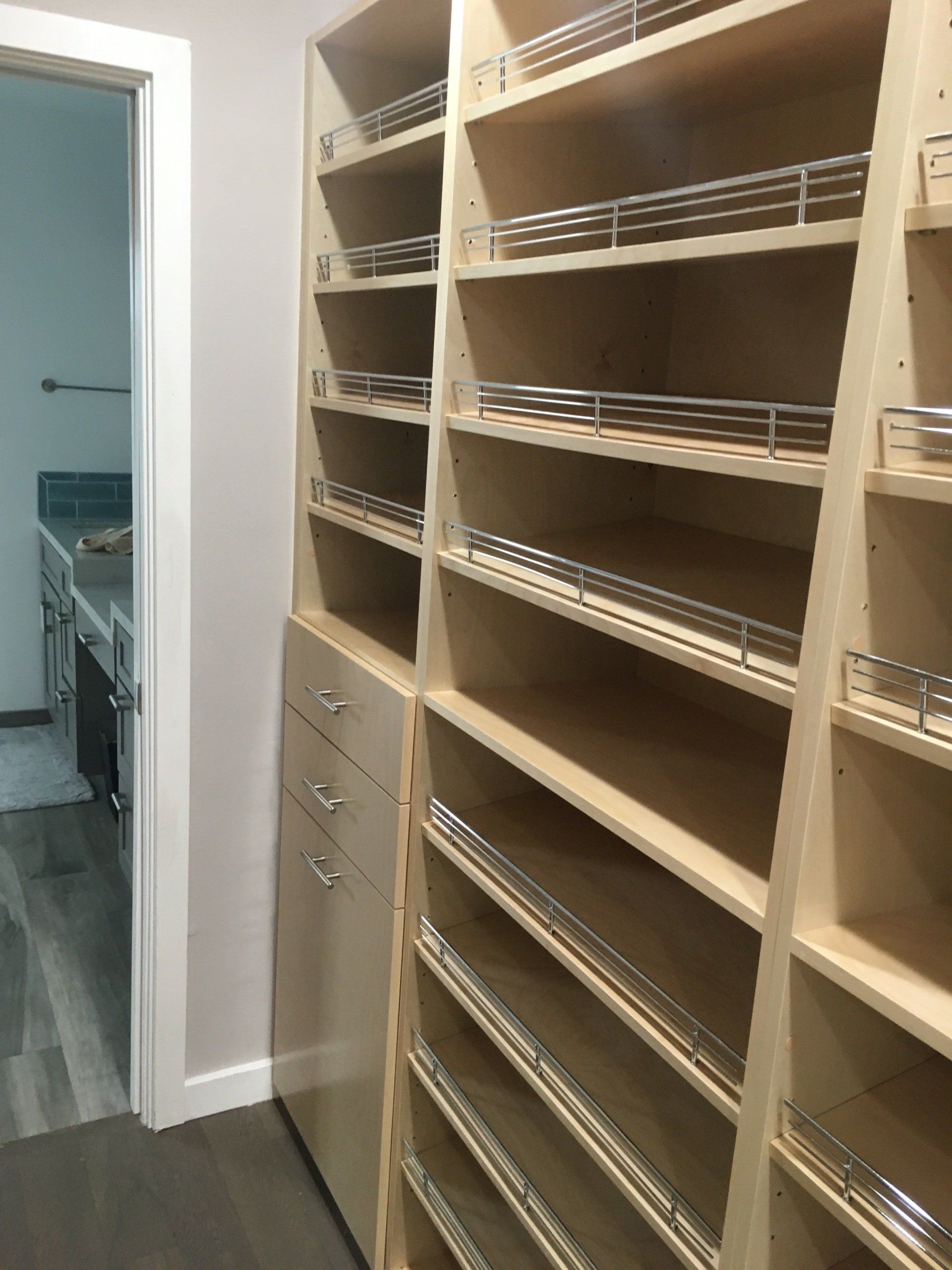 a custom walk-in closet with lots of shoe fences and drawers