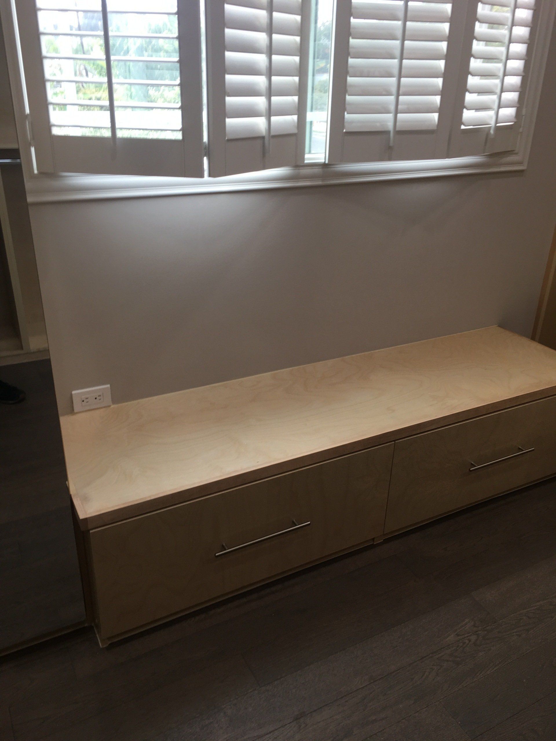 custom walk-in closet with a window seat cabinet