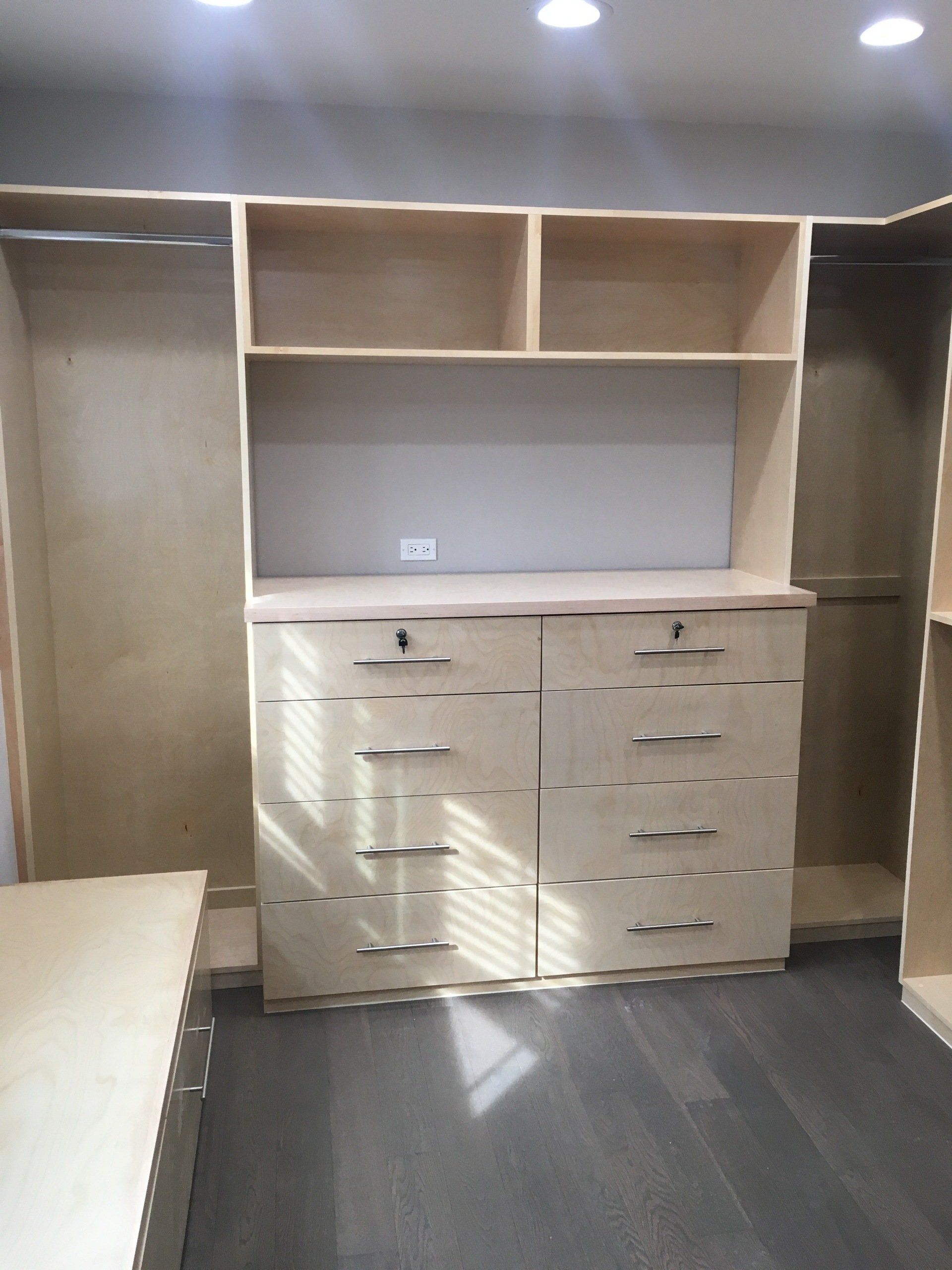 a custom walk-in closet with drawers and hanging space