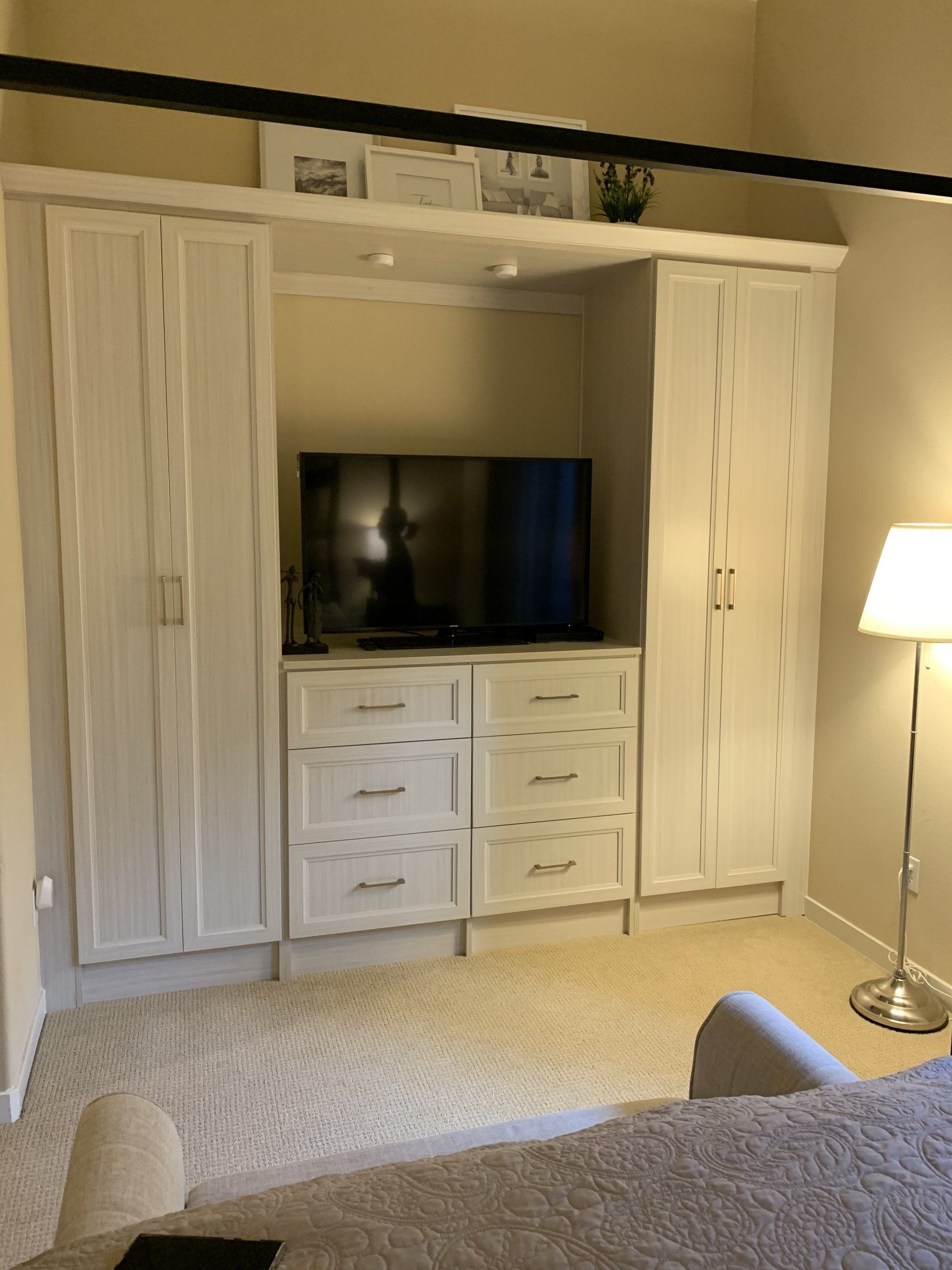 a custom entertainment room cabinet system with flatscreen tv