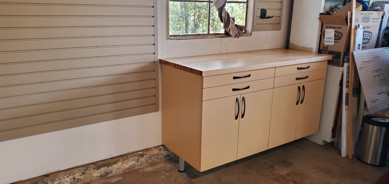 a garage cabinet system with a workbench and cabinets.