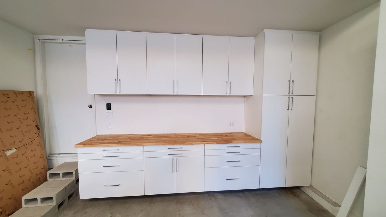 white garage cabinets with workbench