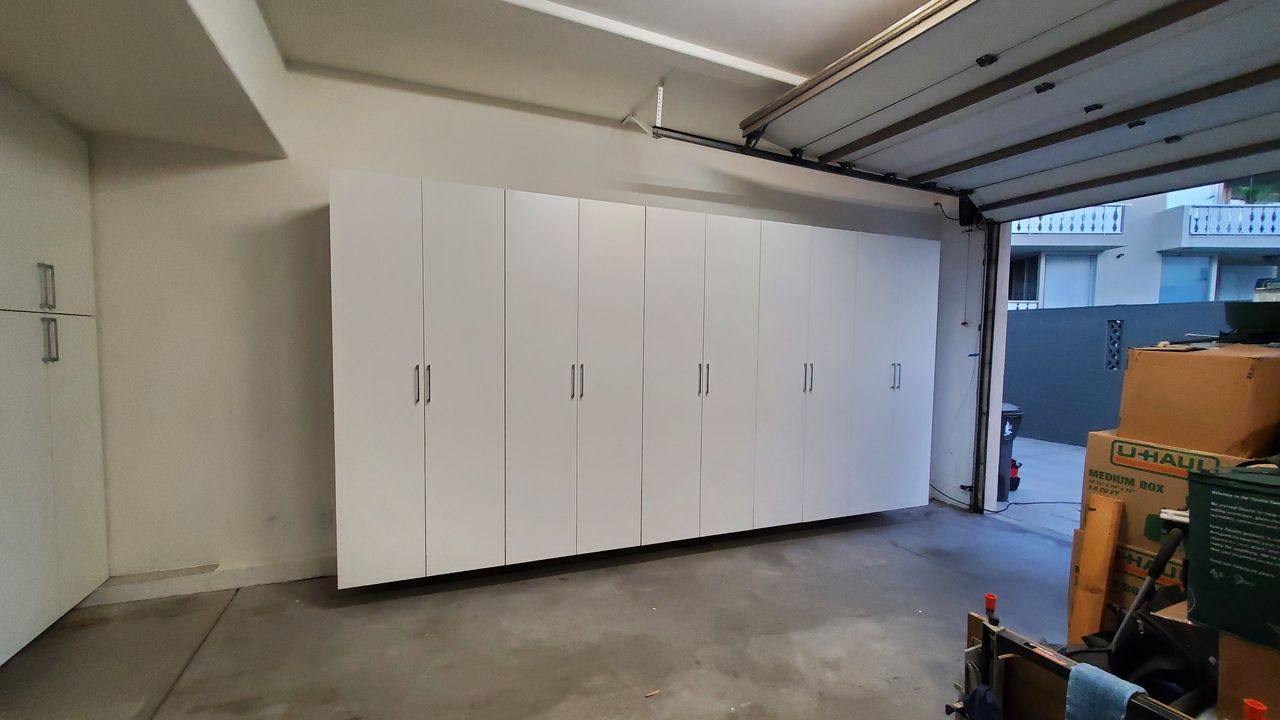 a garage with white cabinets

