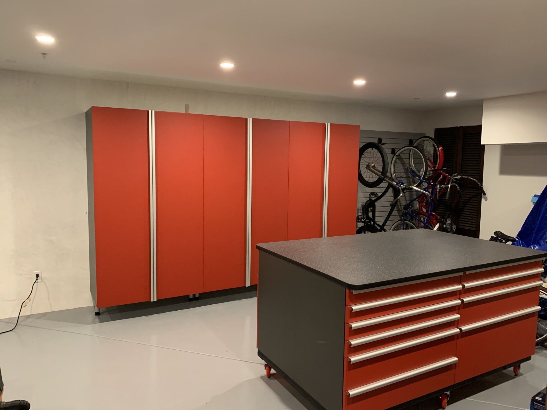 red garage systems with an island counter cabinet 