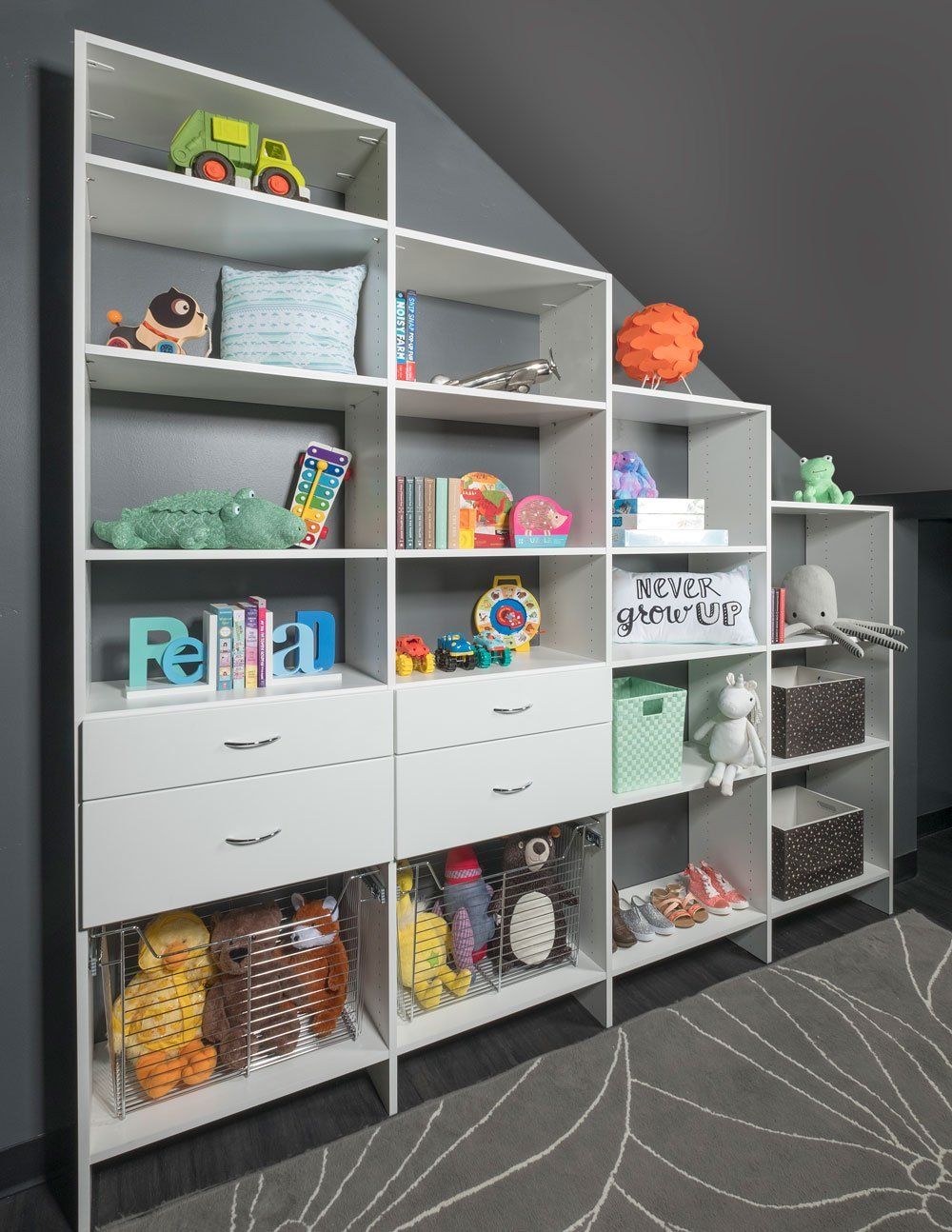 a child's room with a white shelf displaying toys and books
