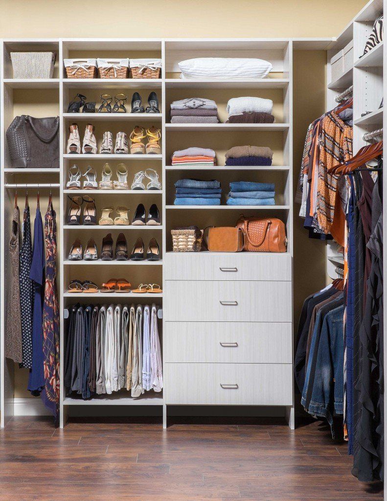 a walk in closet filled with lots of clothes and shoes