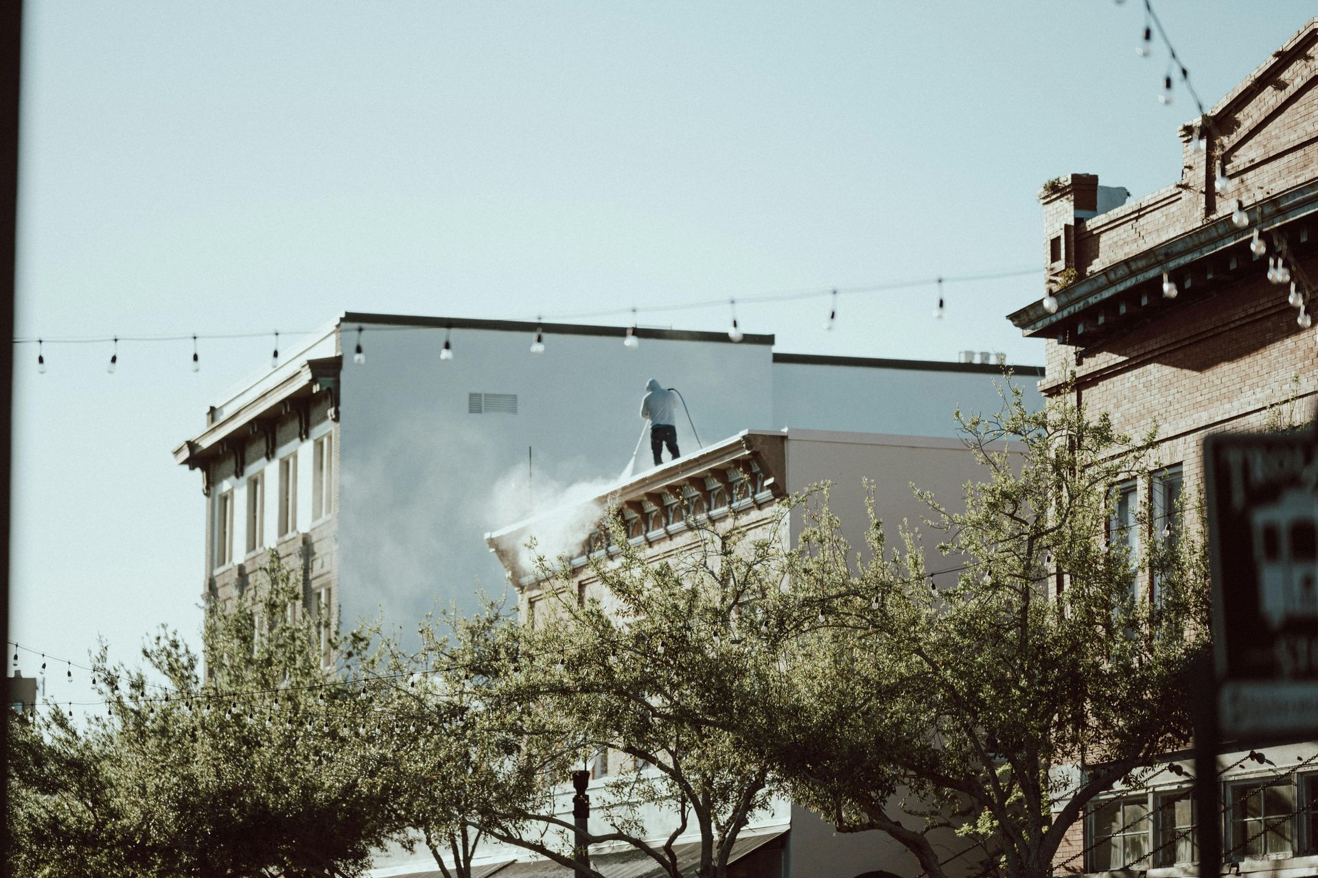 A man is standing on the roof of a building.