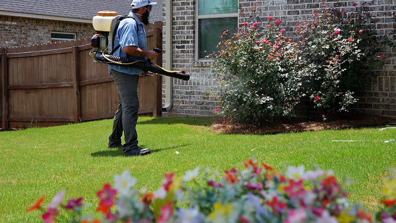 Lawn care professional applying products to a lawn