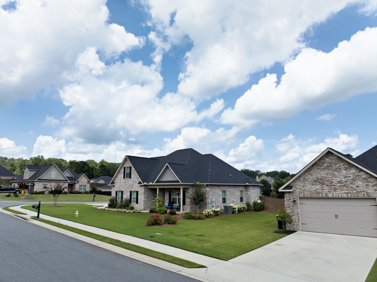 Healthy front yard grass maintained by Turf Magic in Monroe County