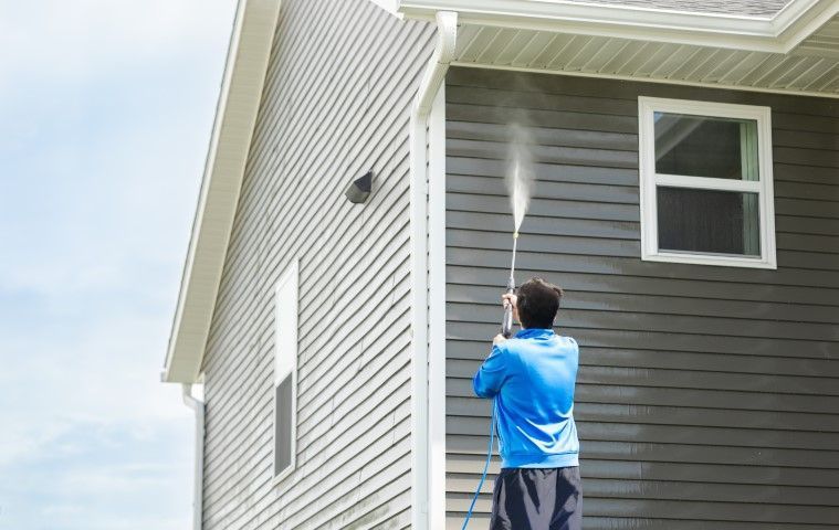 Jurupa Valley Pressure Washing  technician cleaning house