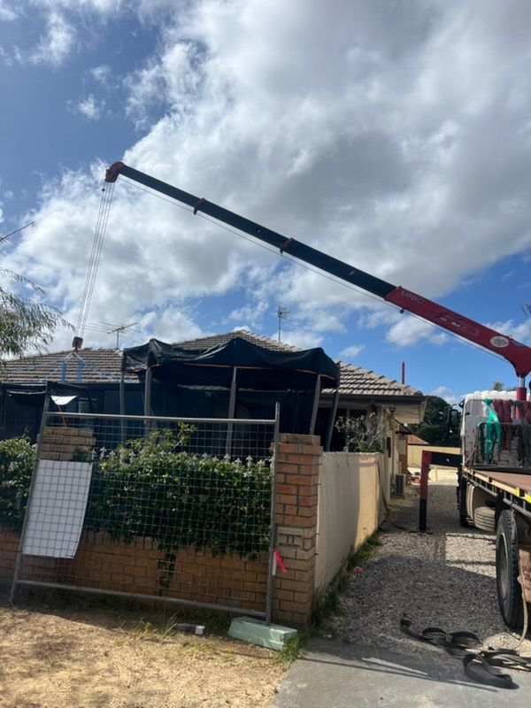 A semi truck is carrying a large excavator on a trailer.