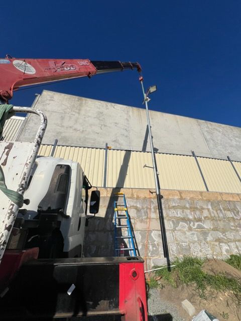 A semi truck is carrying a large excavator on a trailer.