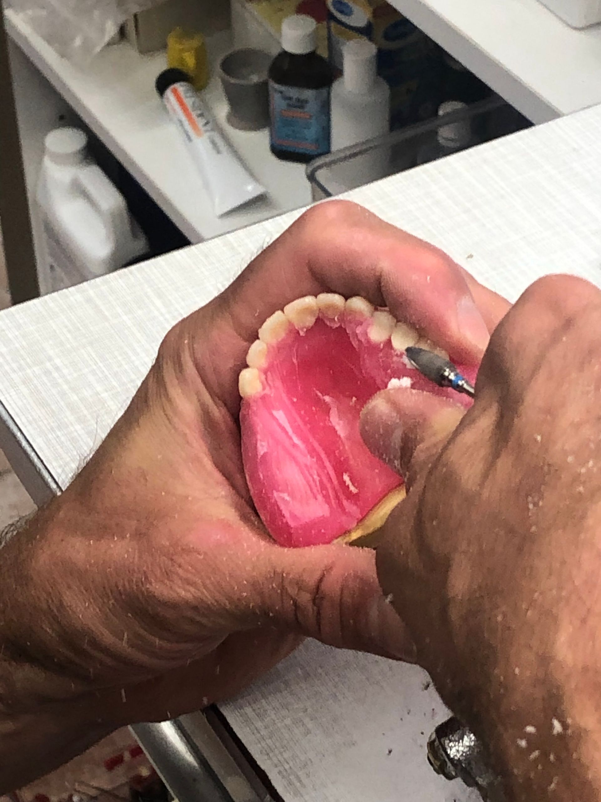 Hands Carving a Pink Denture, Close-up Shot — My Denture Clinic in Tamworth, NSW