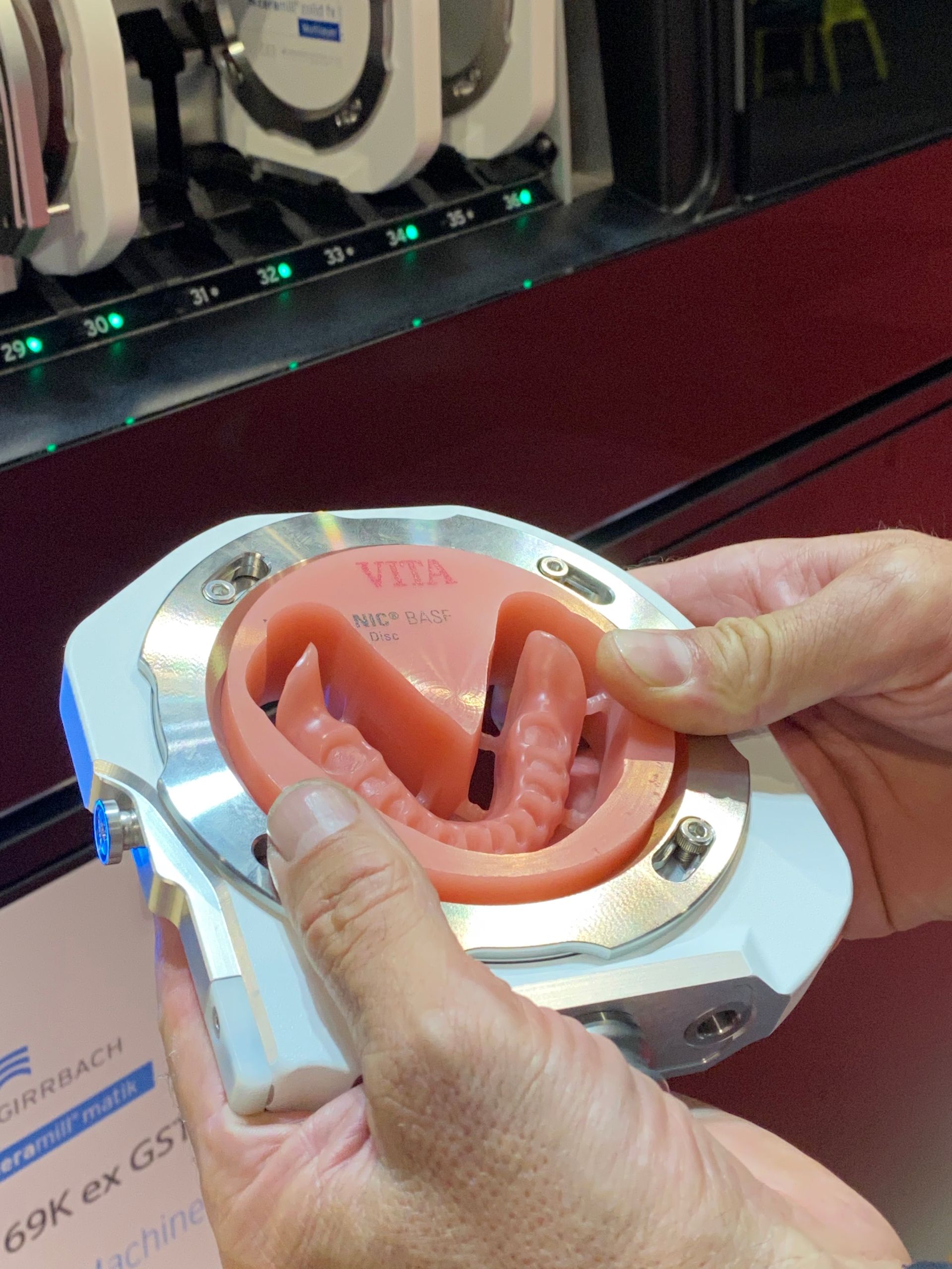Hands Holding a Dental Mold With Pink Gums and Teeth — My Denture Clinic in Benowa, QLD