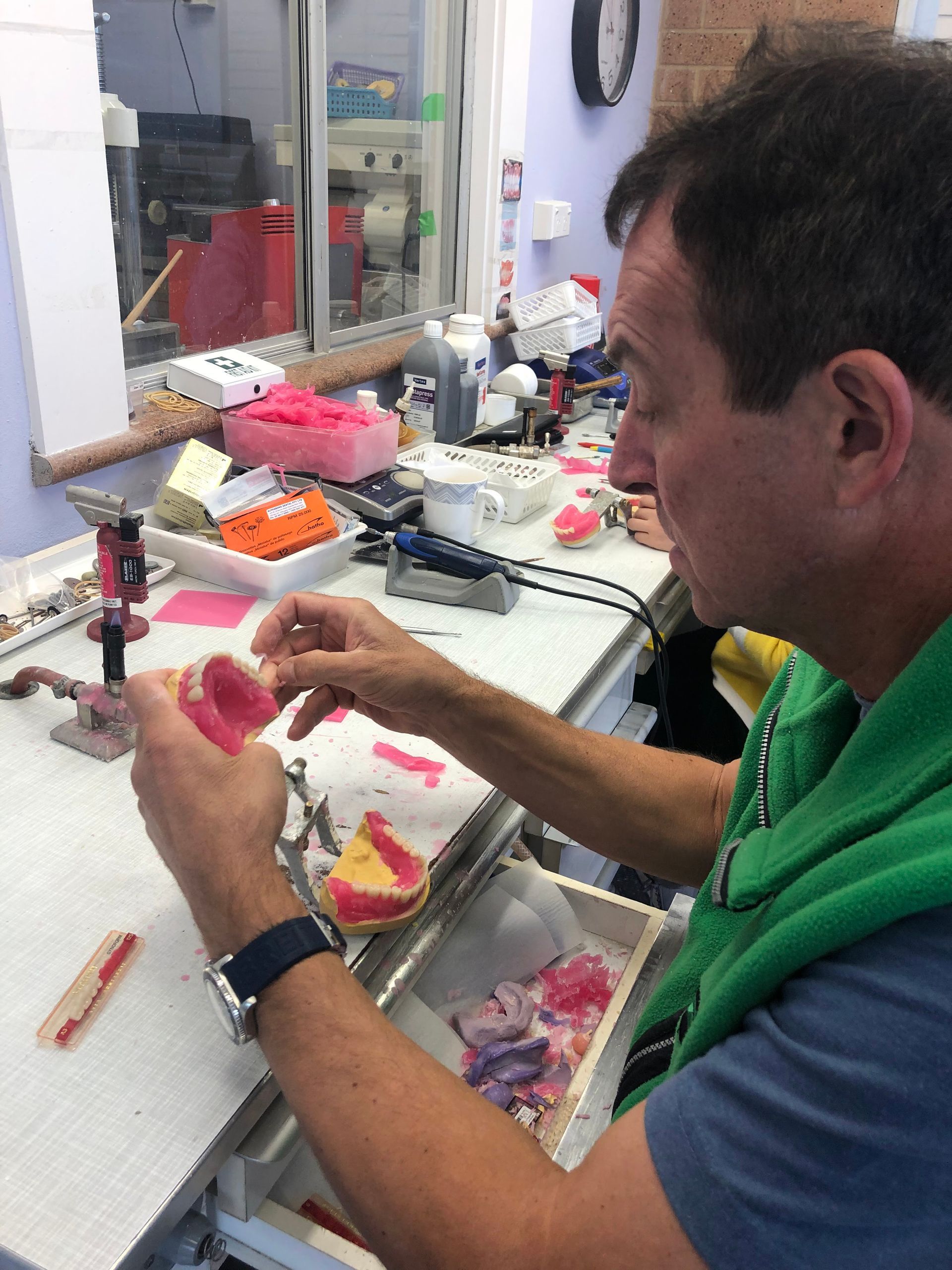 Man Working on Dental Prosthetics in a Lab — My Denture Clinic in Benowa, QLD