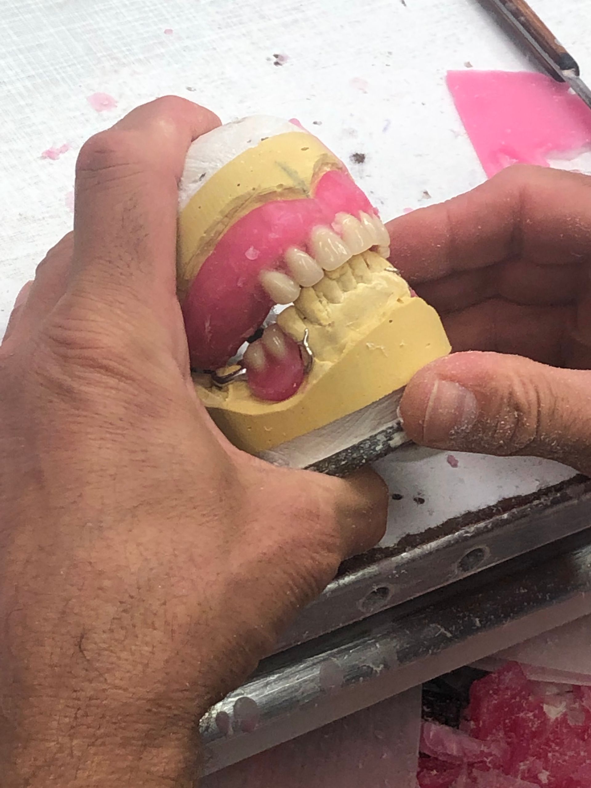 Hands Holding a Dental Mold With Pink Wax — My Denture Clinic in Gold Coast, QLD