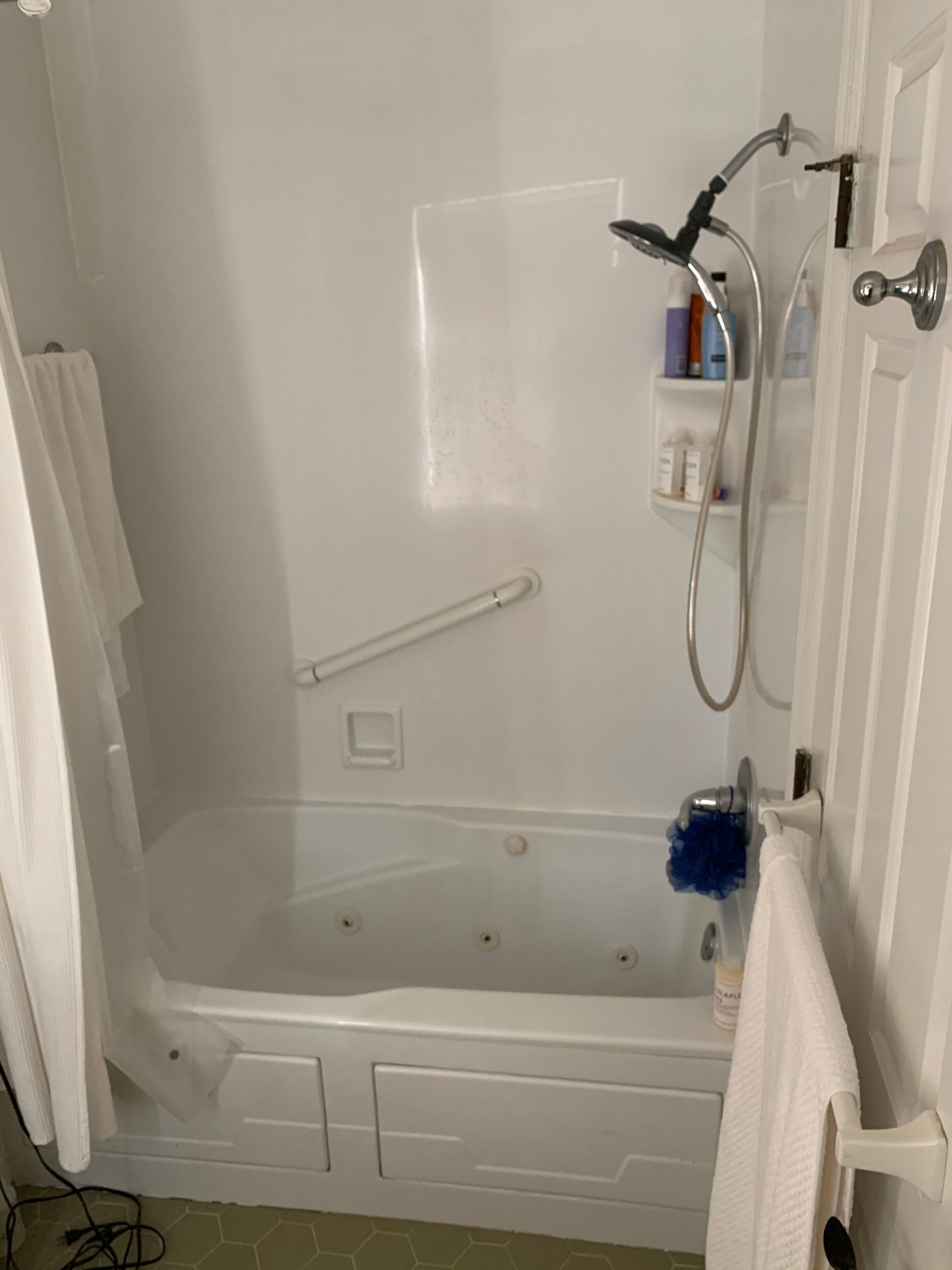 A bathroom with a bathtub and a shower.