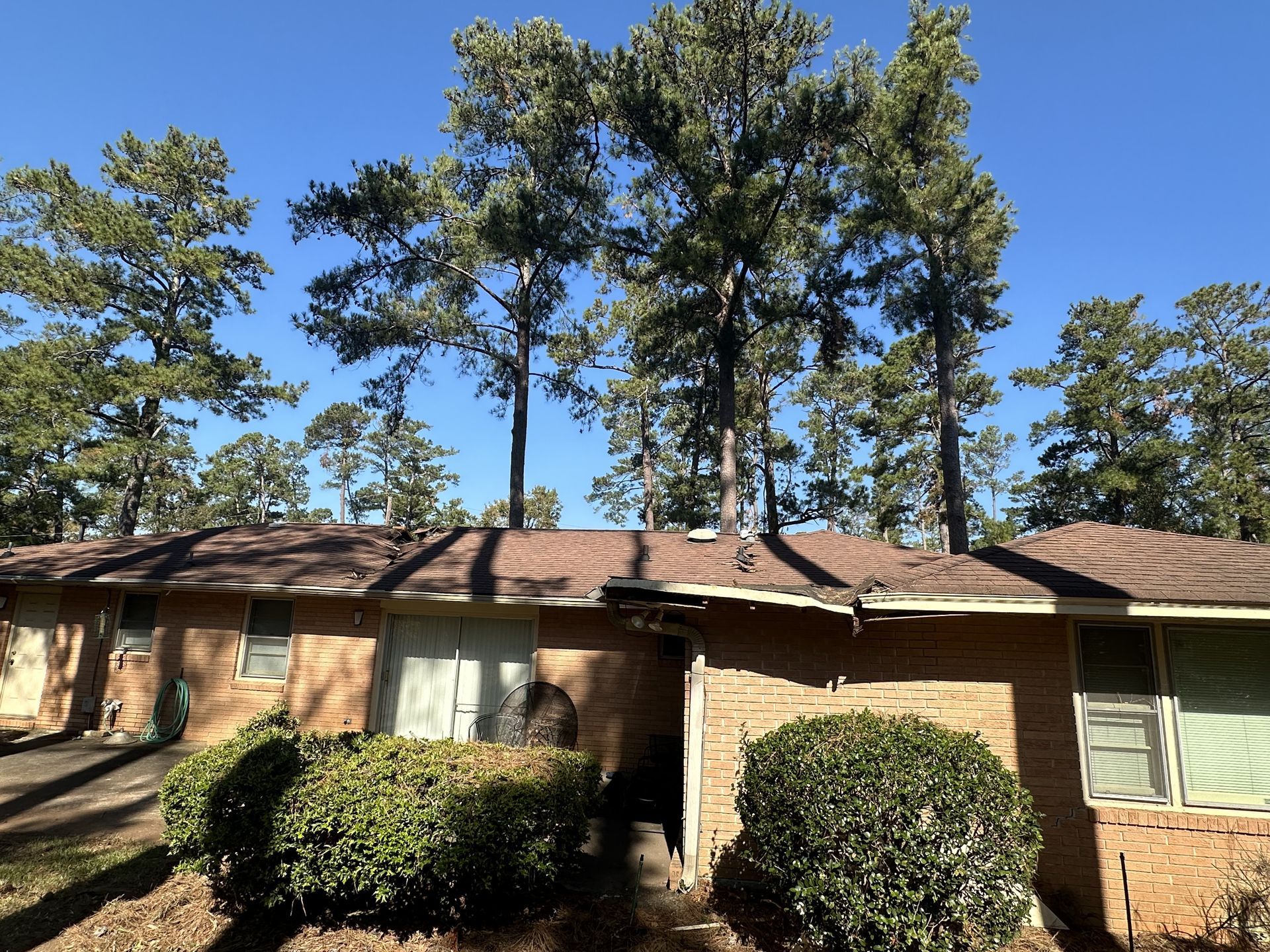 A brick house with trees in front of it