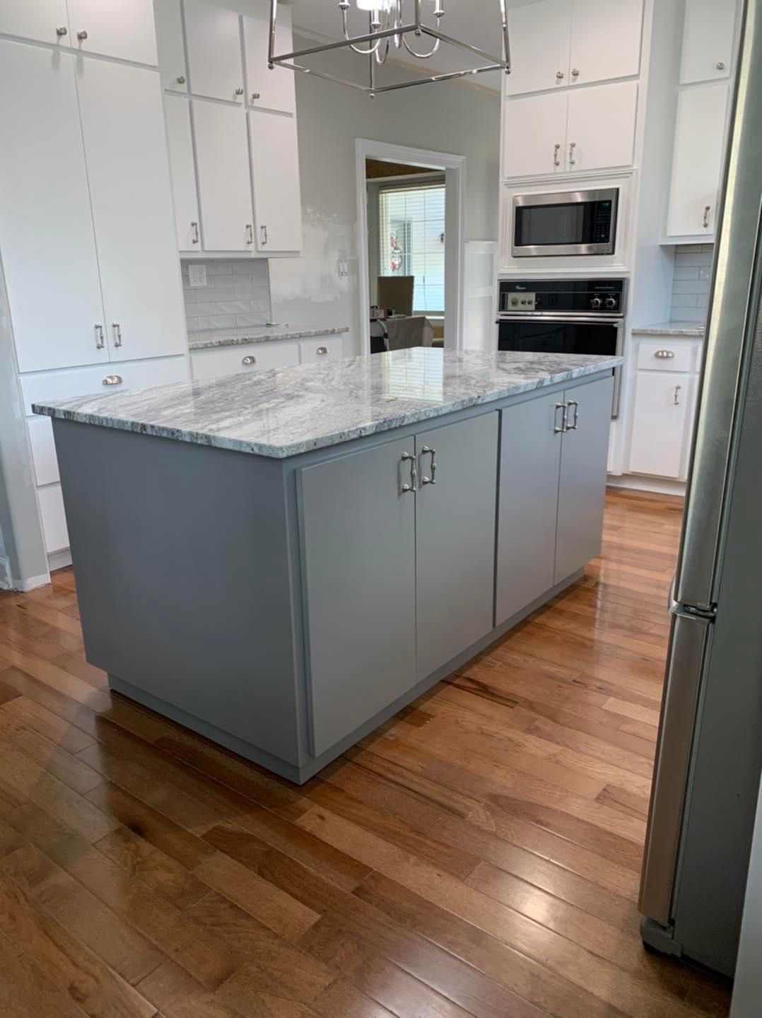 There is a large island in the middle of the kitchen.