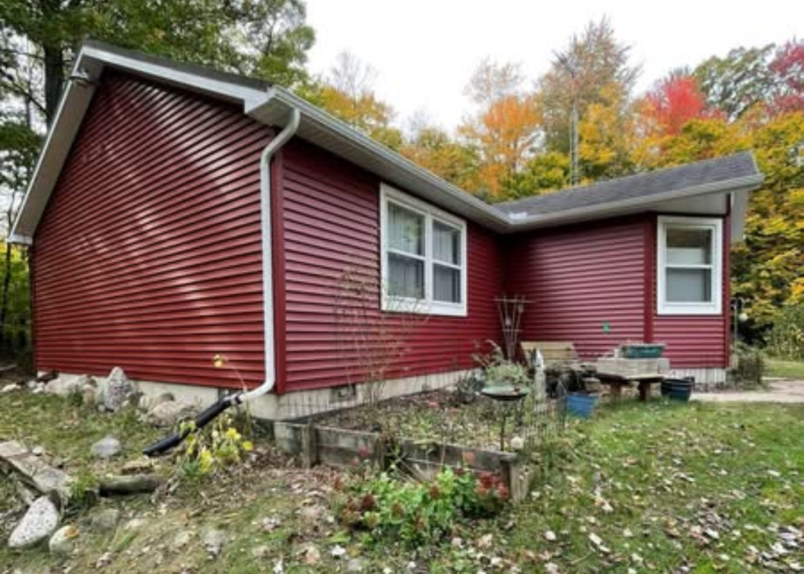 Close-up of a black metal roof with attached gutters.