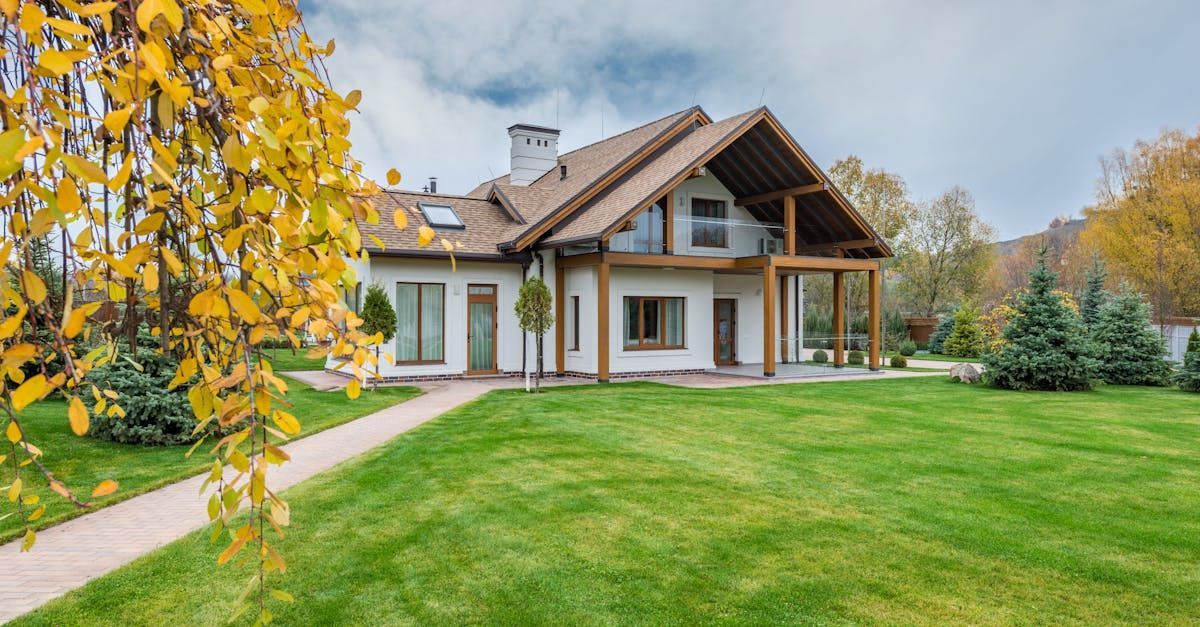 A large house with a lush green lawn in front of it.