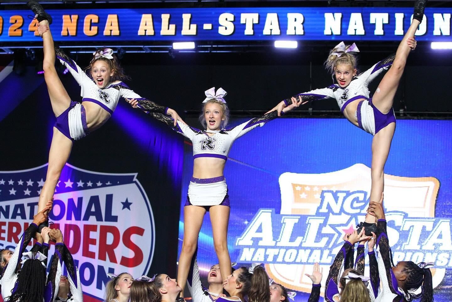 A group of cheerleaders are performing in front of a banner that says nca all-star nation