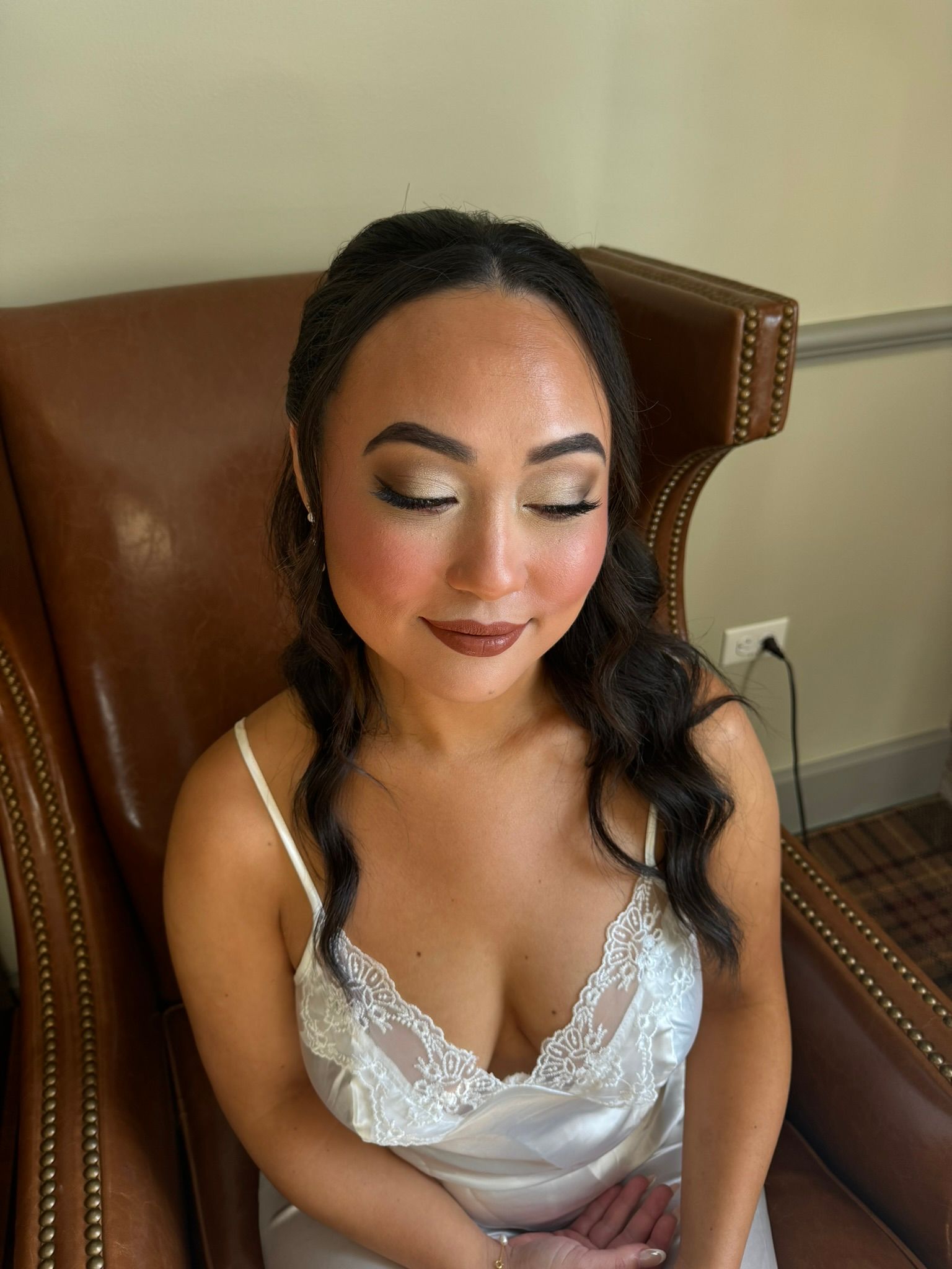 A woman is sitting in a chair with her eyes closed