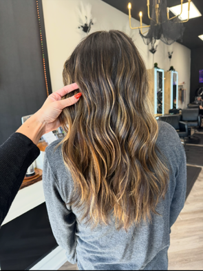A woman is getting her hair done in a salon