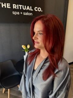 Woman with red hair in a silver robe at a spa and salon, the Ritual Co.