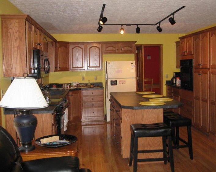 A kitchen with wooden cabinets and a white refrigerator