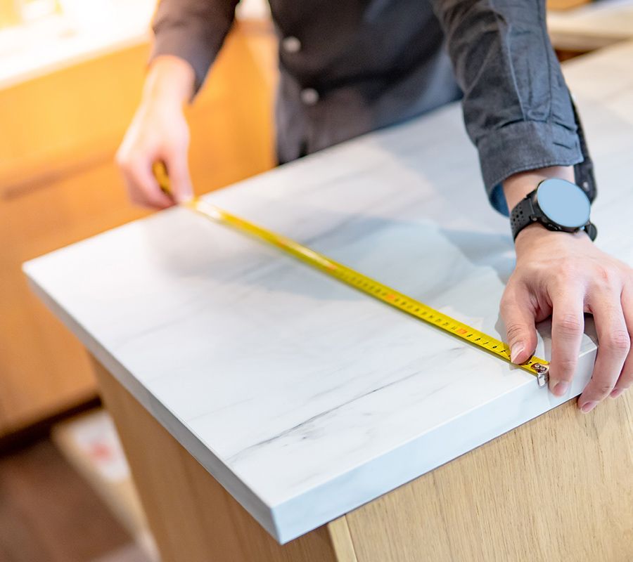 Man Measuring The Countertop