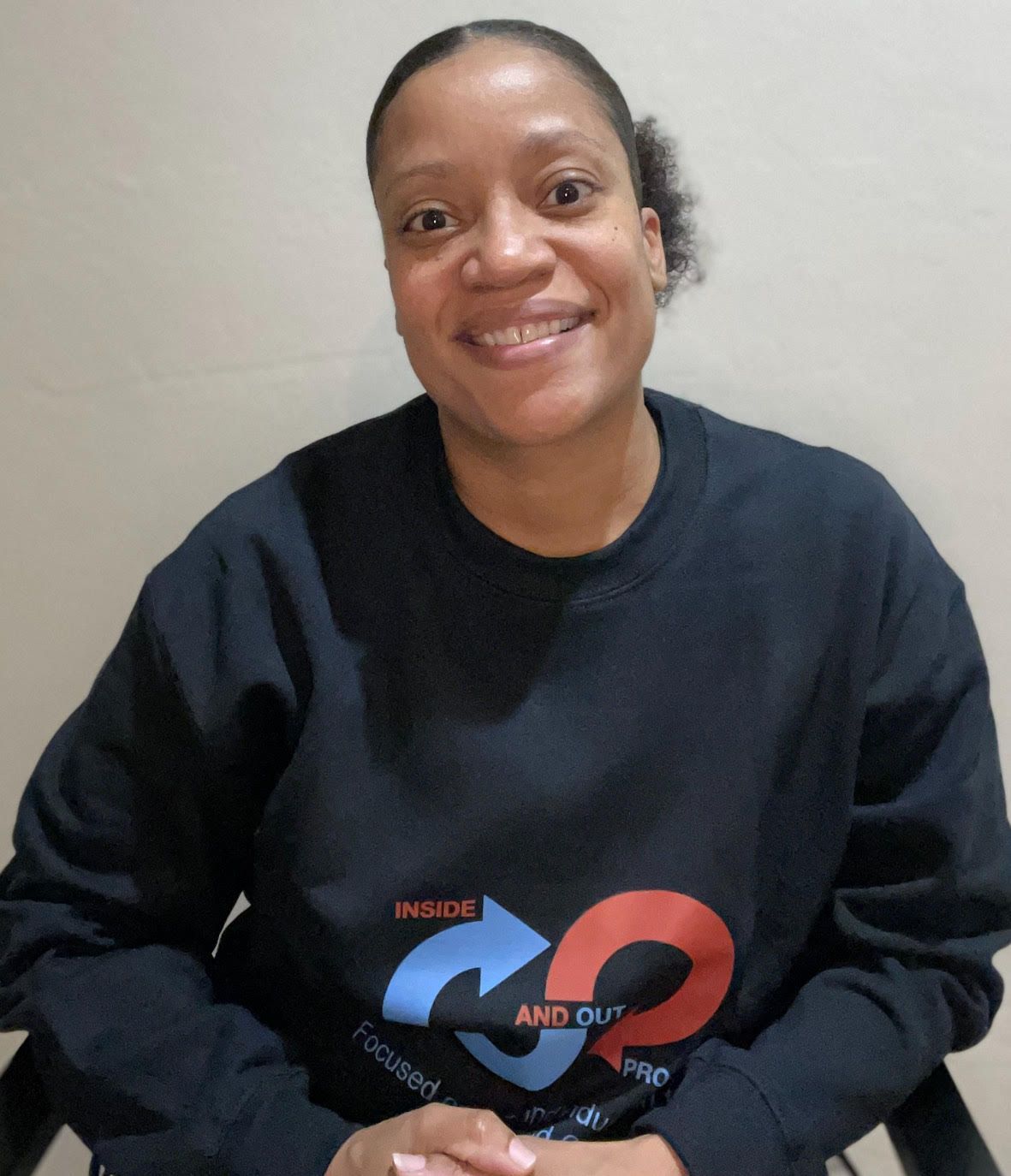 A woman wearing a sweatshirt that says inside and out