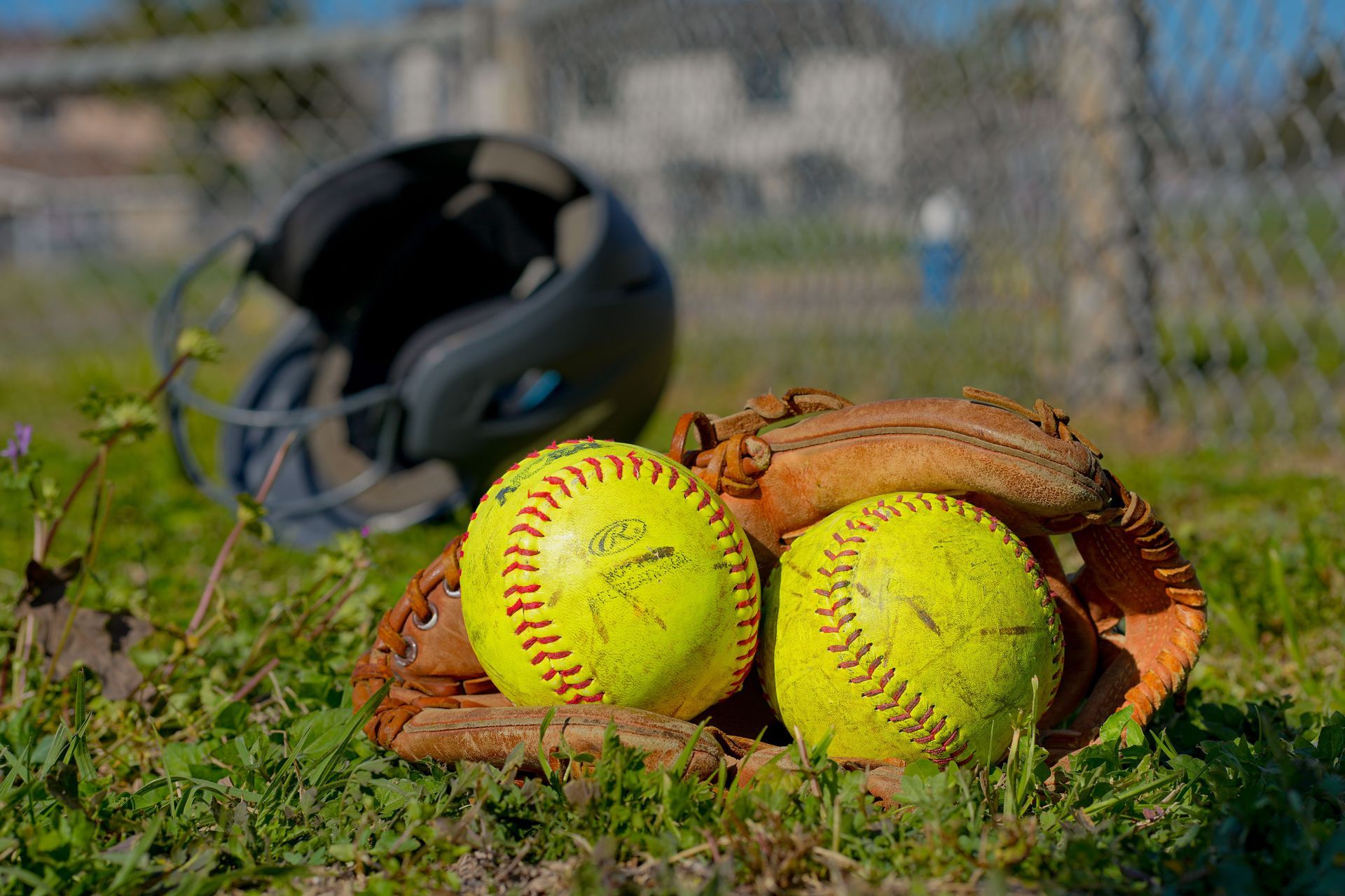 Softball and glove on a field