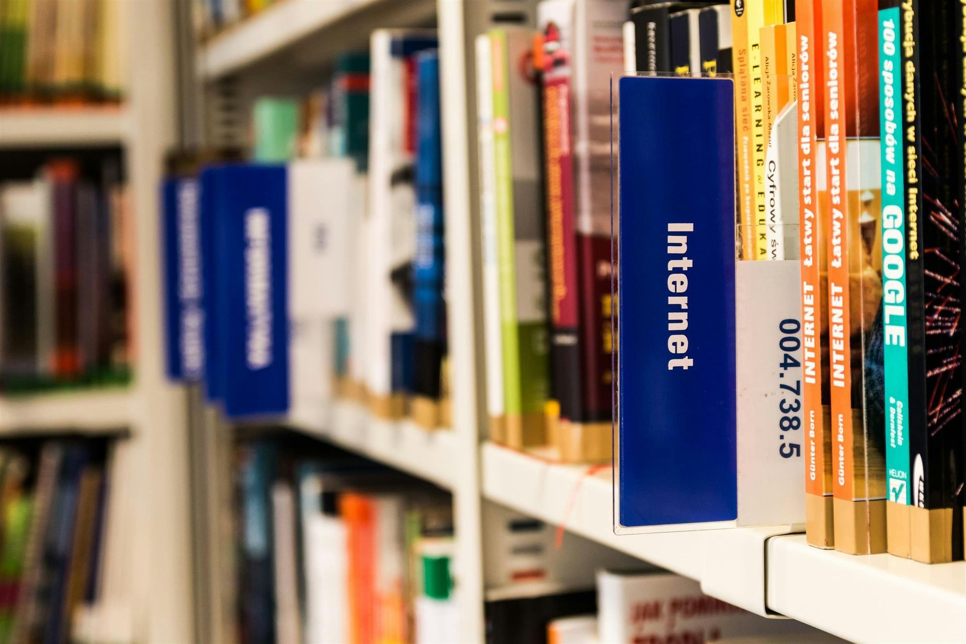 Books on a library shelf, a blue spine labeled