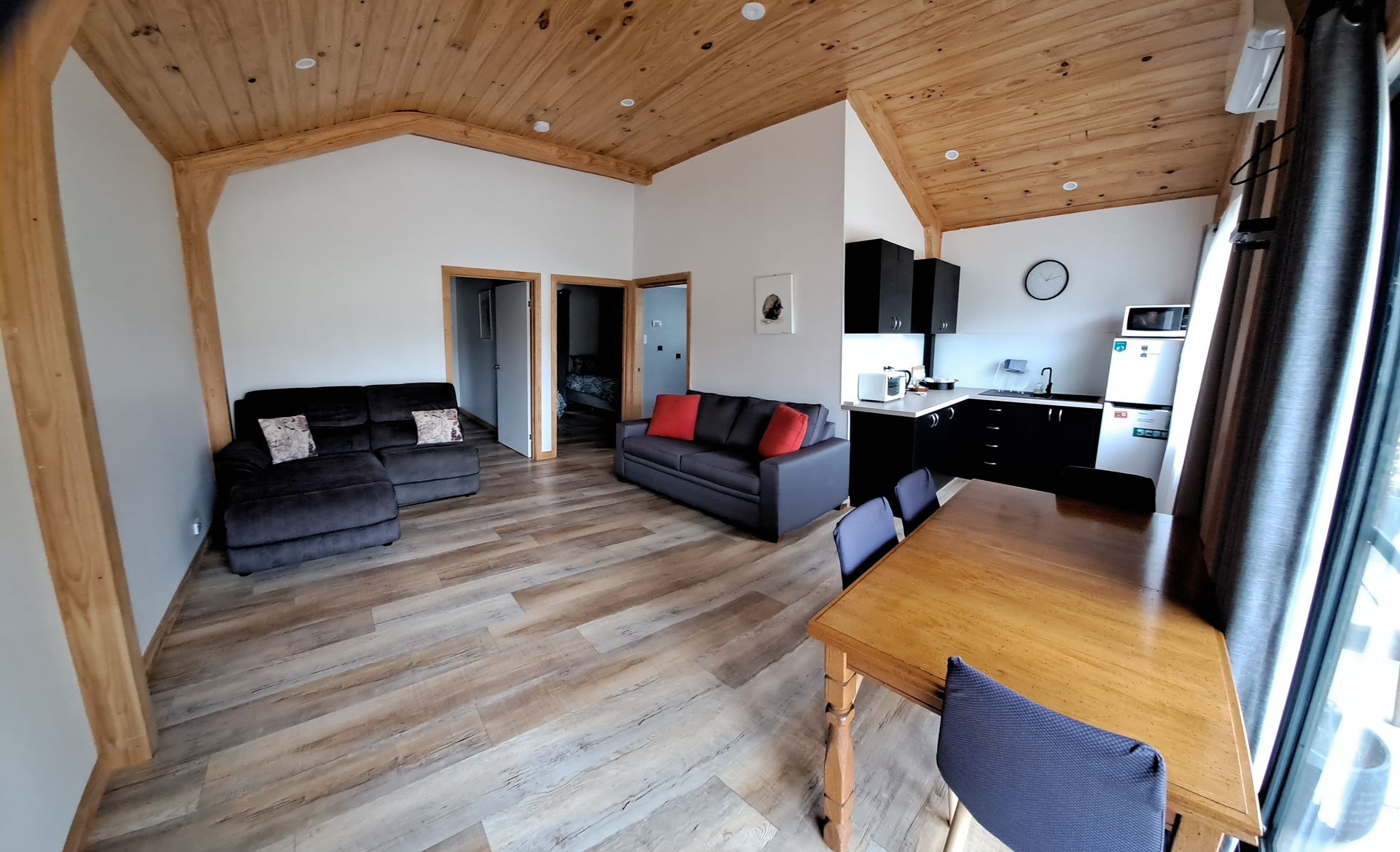 A living room with a couch , table and chairs