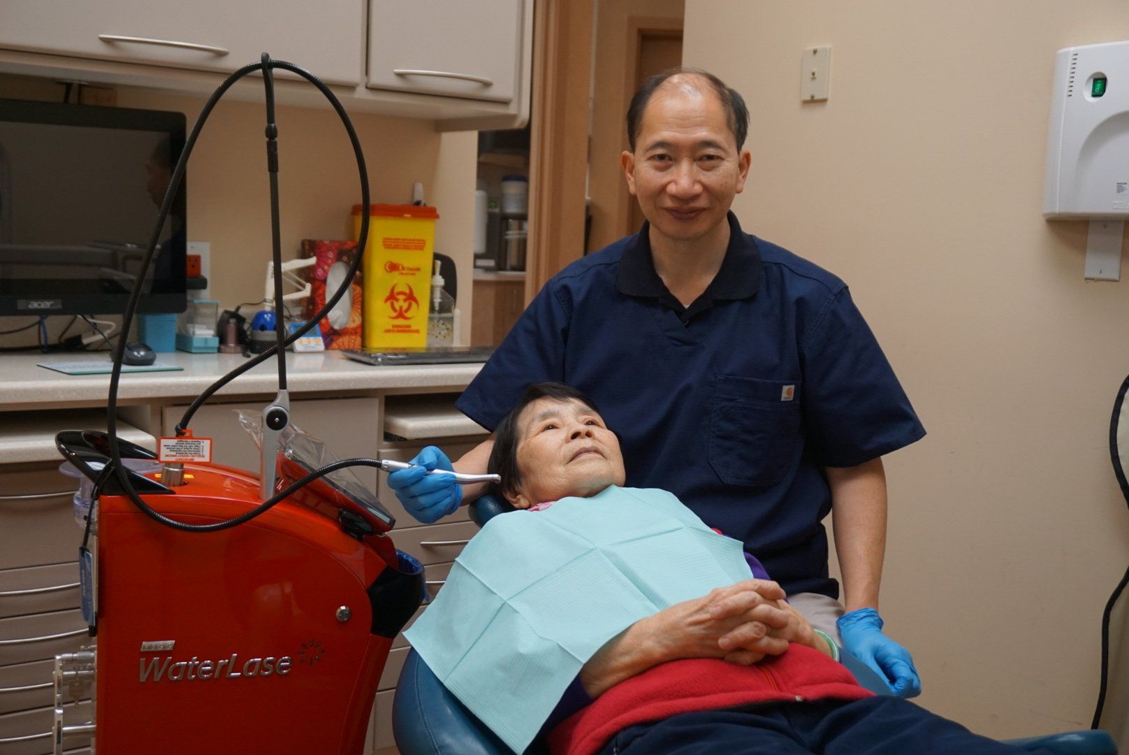 Dr. Kin performing laser therapy on a patient