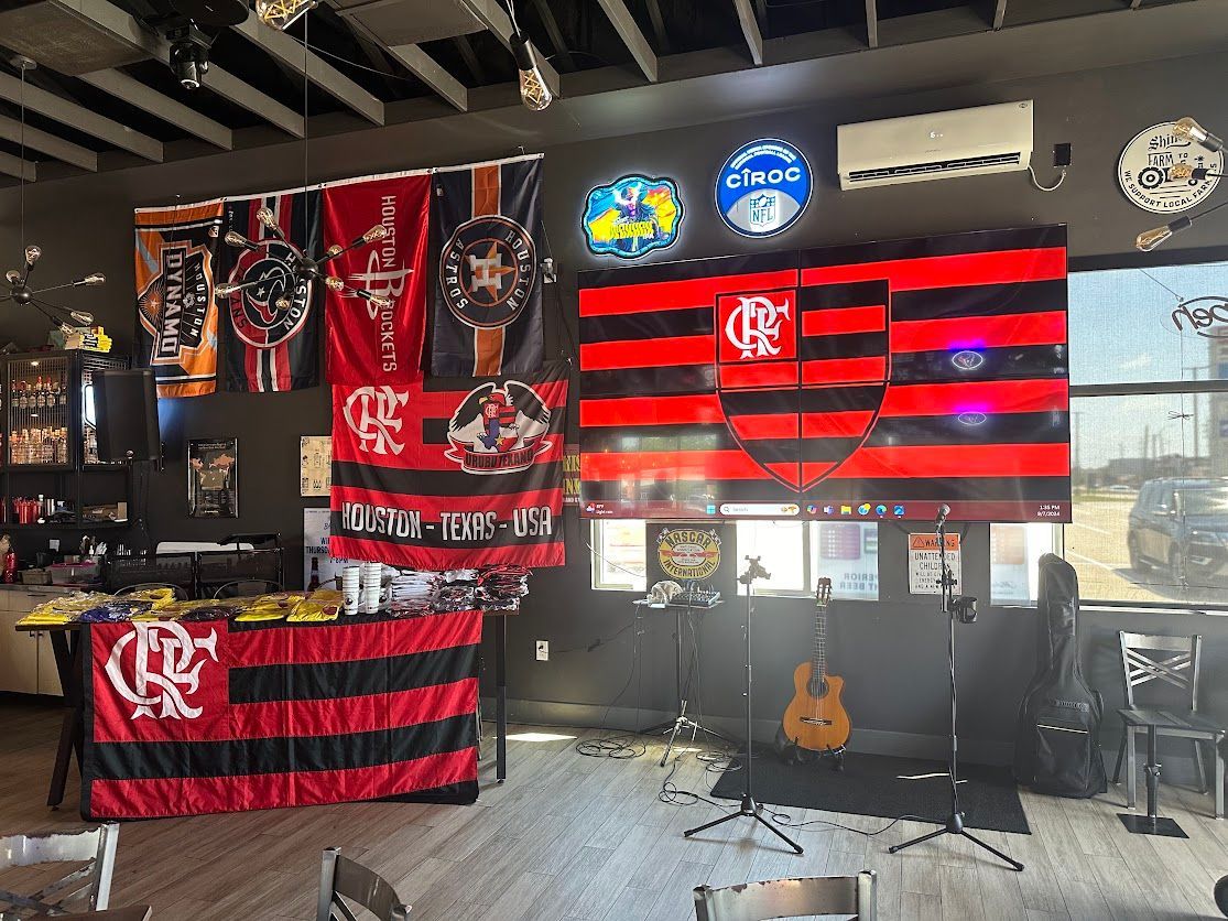A room with a lot of flags on the wall and a guitar.
