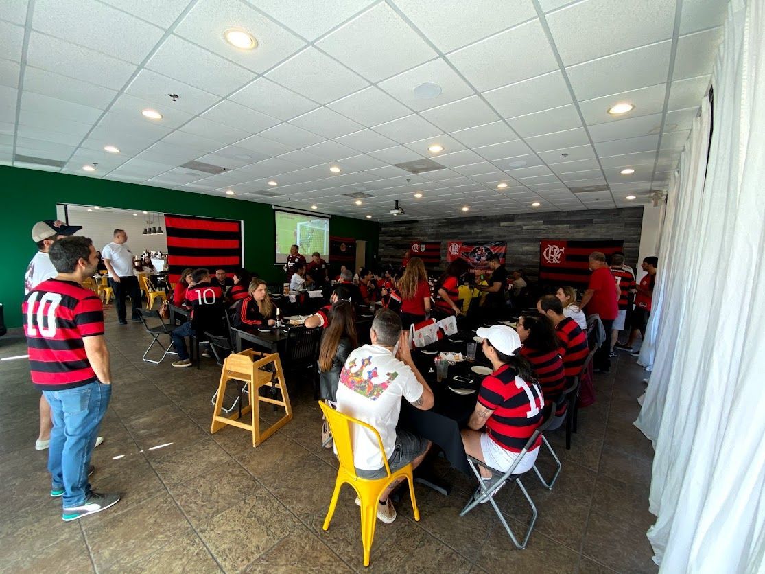 A group of people are sitting at tables in a large room.