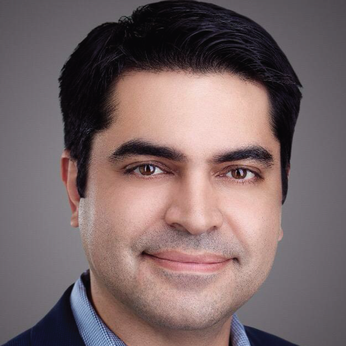 A close up of a man 's face with a smile on his face.