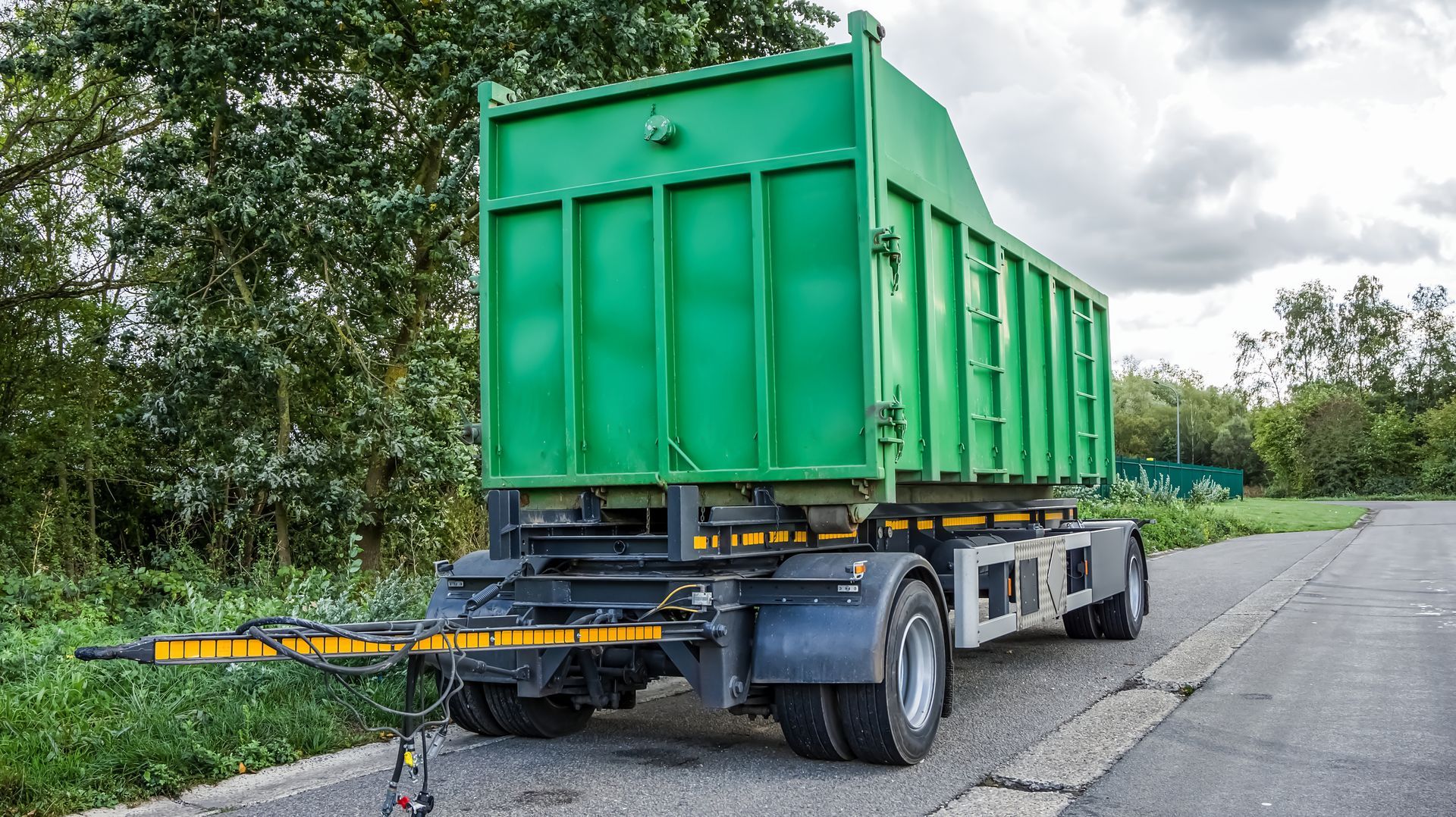 A white, minimalist, minimalist-style interior with a large arched doorway, arched windows, and a hanging pendant light.