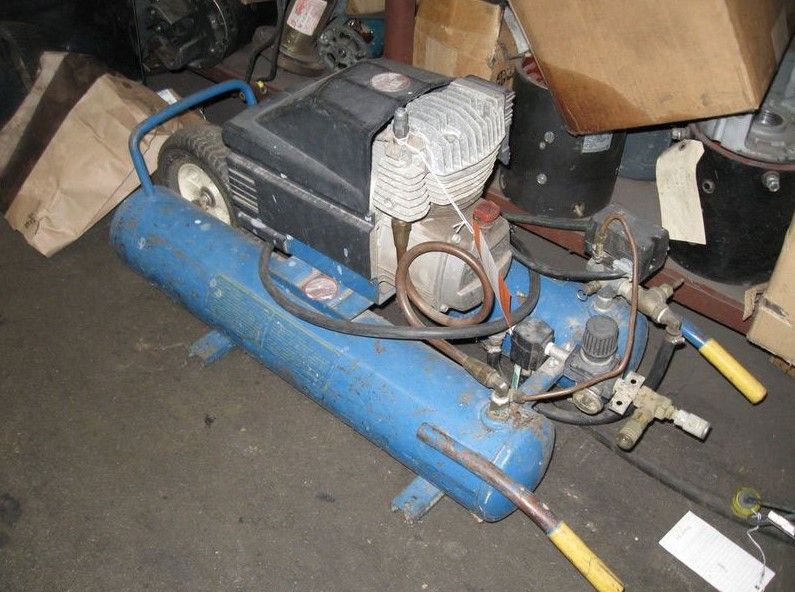 An air compressor with a blue tank and yellow handles