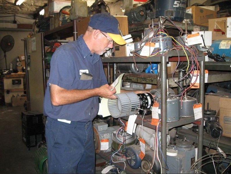 A man in a blue shirt is looking at a piece of paper