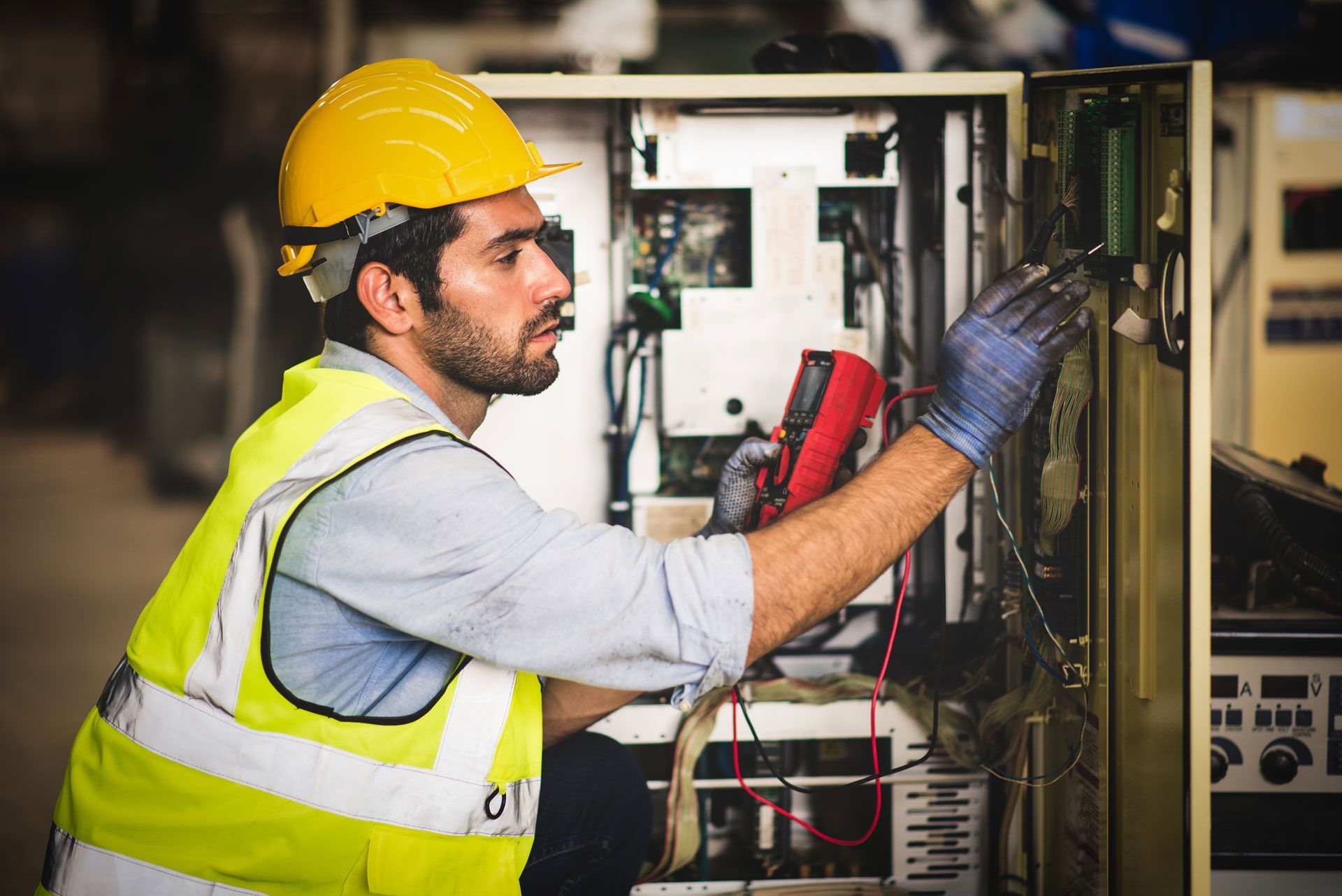 A man wearing black gloves is working on a gearbox.