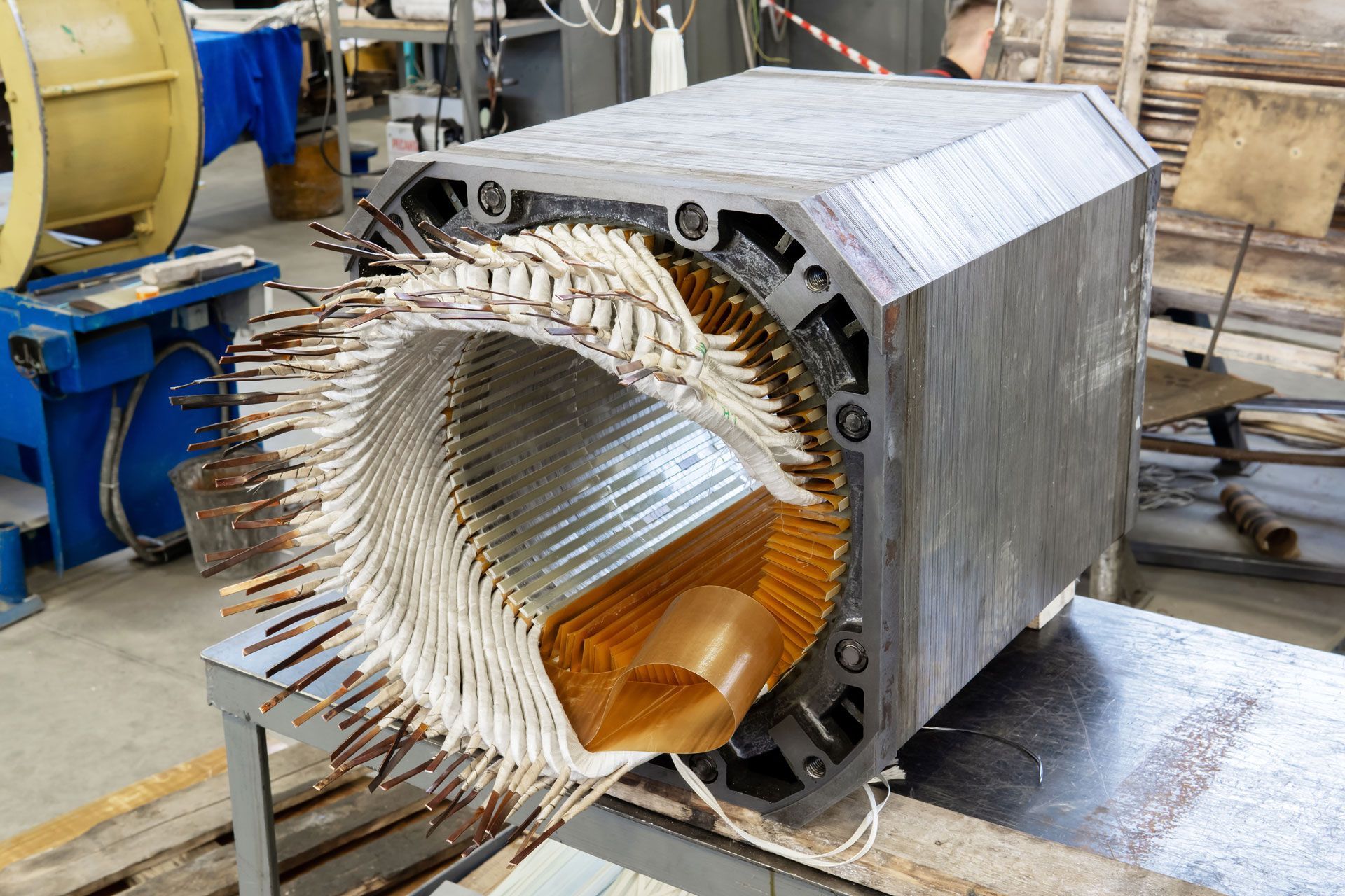 A person wearing white gloves is working on a clutch plate.