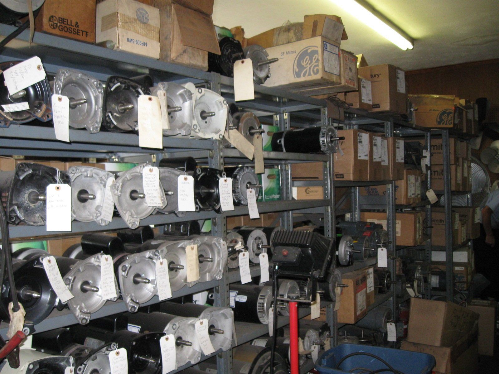 A warehouse filled with lots of parts and boxes including one that says ' gm ' on it