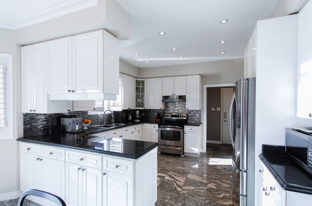 A Kitchen With White Cabinets and Stainless Steel Appliances — Hunter Kitchen King In New Lambton, NSW