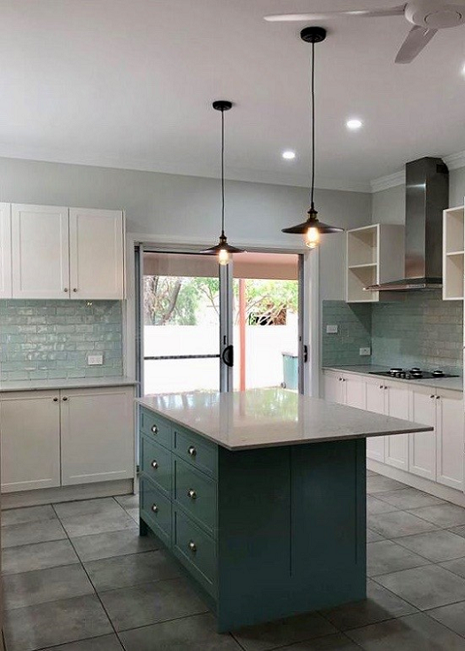 A kitchen with a large island in the middle and a ceiling fan — Hunter Kitchen King In Rutherford, NSW