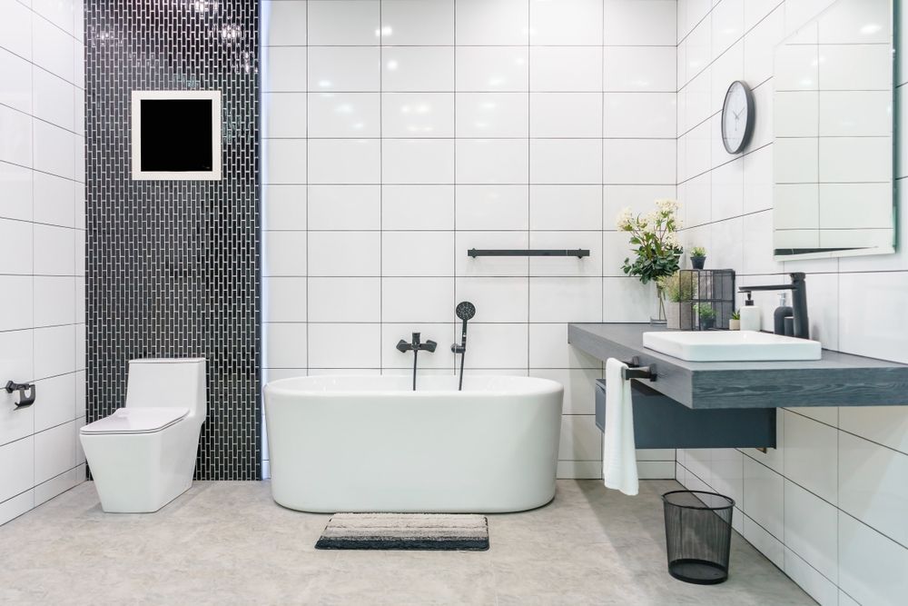 A Bathroom With a Bathtub and Mirror — Hunter Kitchen King In Lake Macquarie, NSW